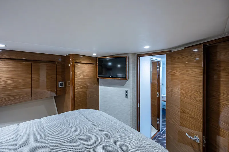 Slide: The Image of Luxurious cabin interior of 2023 Viking 48 Sport Tower yacht with wood finishes. - 19
