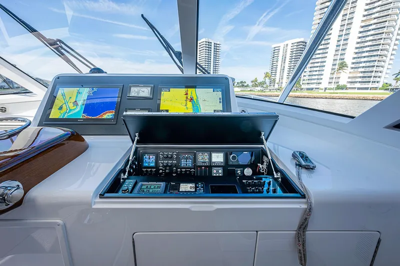 Slide: The Image of 2023 Viking 48 Sport Tower helm with advanced navigation displays and controls. - 22
