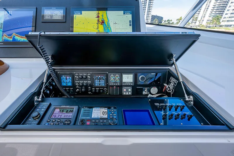 Slide: The Image of Control panel of 2023 Viking 48 Sport Tower with advanced navigation and communication systems. - 23