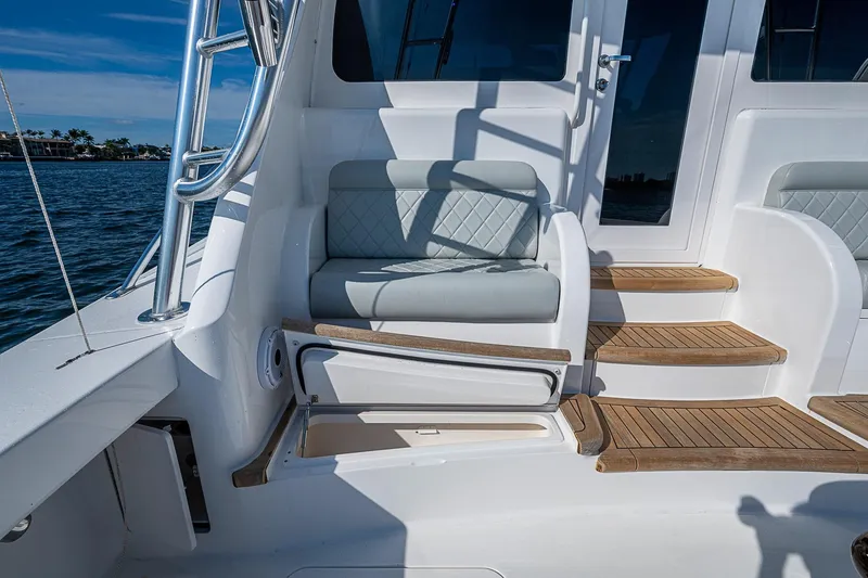 Slide: The Image of 2023 Viking 48 Sport Tower yacht with elegant seating and teak steps. - 36
