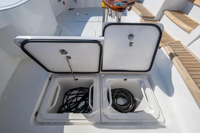 Slide: The Image of Open storage compartments on 2023 Viking 48 Sport Tower boat deck. - 38