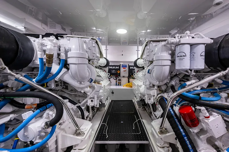 Slide: The Image of Engine room of 2023 Viking 48 Sport Tower with MAN engines and blue hoses. - 47