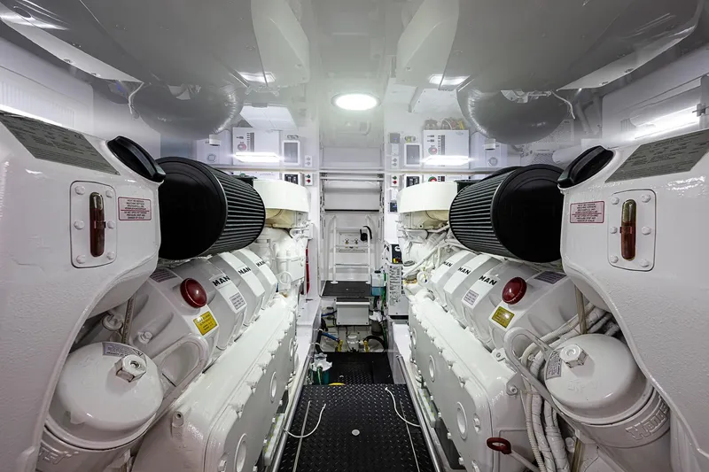 Slide: The Image of Engine room of 2023 Viking 48 Sport Tower, featuring dual engines and modern equipment. - 49