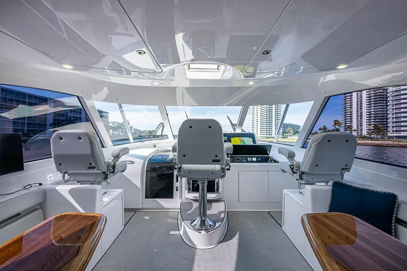 Slide: The Image of Interior of 2023 Viking 48 Sport Tower yacht with modern helm and seating. - 5