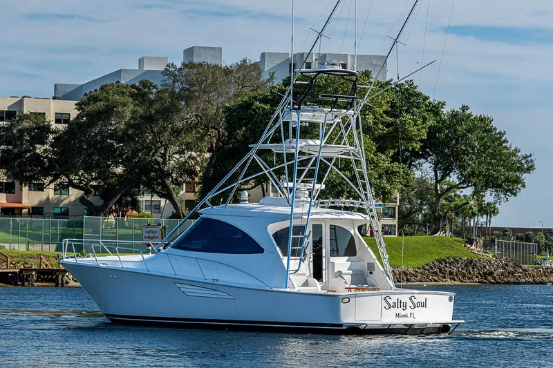 Slide: The Image of 2023 Viking 48 Sport Tower yacht "Salty Soul" cruising near Miami shoreline. - 56