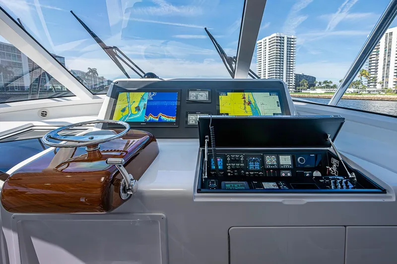 Slide: The Image of 2023 Viking 48 Sport Tower helm with navigation screens and controls. - 6