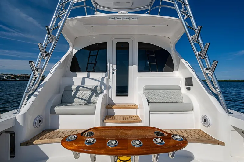 Slide: The Image of 2023 Viking 48 Sport Tower yacht with elegant seating and fishing rod holders. - 7
