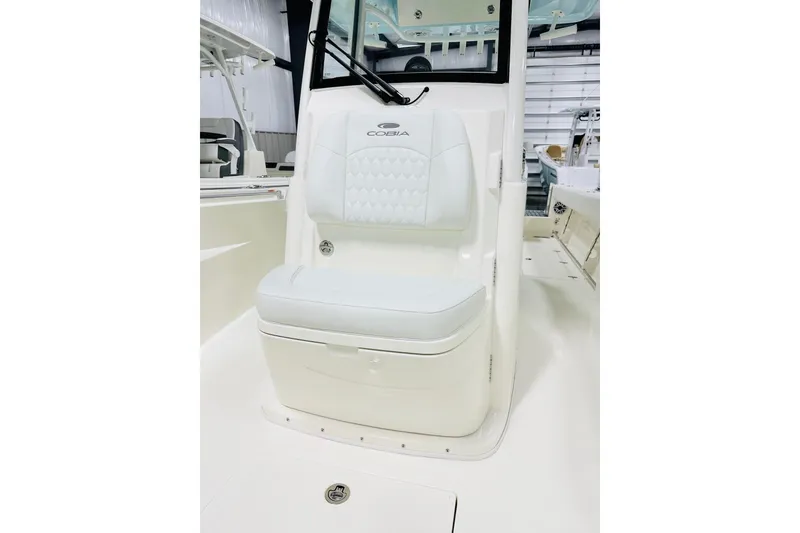 Slide: The Image of 2026 Cobia 285 Center Console boat interior with white cushioned seating. - 10