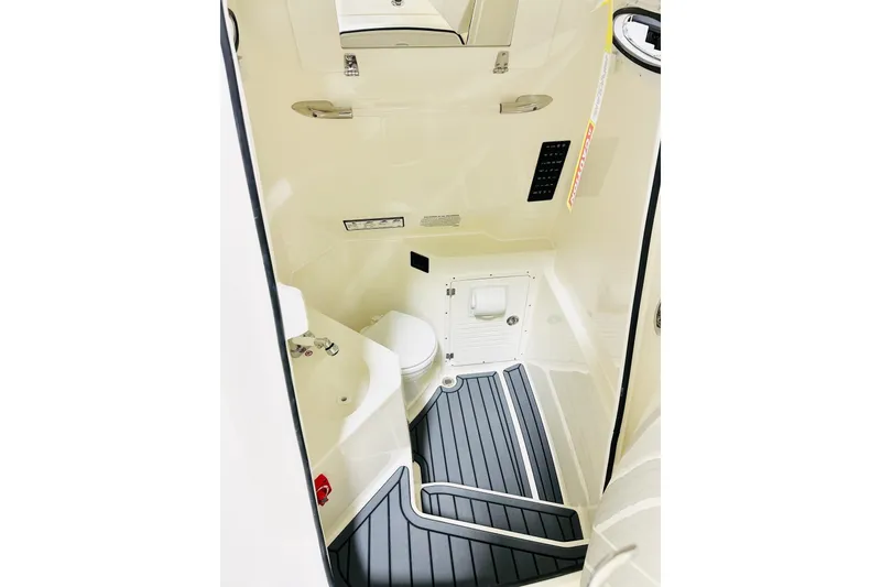 Slide: The Image of 2026 Cobia 285 Center Console boat interior with toilet and modern design. - 12