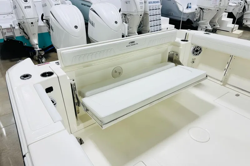 Slide: The Image of 2026 Cobia 285 Center Console boat with foldable seating and twin outboard engines. - 14