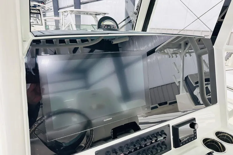 Slide: The Image of 2026 Cobia 285 Center Console dashboard with Garmin display and controls. - 3