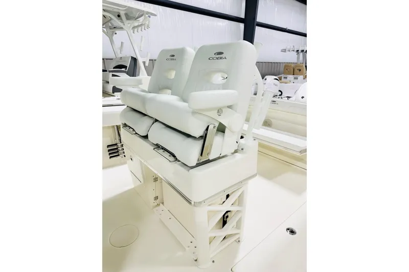 Slide: The Image of 2026 Cobia 285 Center Console boat seating in a showroom. - 4