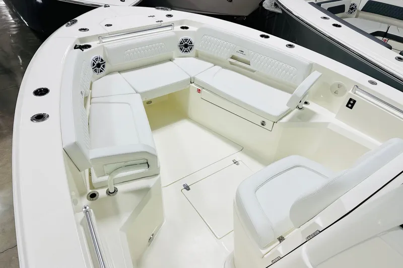 Slide: The Image of 2026 Cobia 285 Center Console boat interior with white seating and modern design. - 7