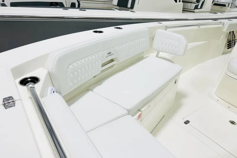 Slide: The Image of 2026 Cobia 285 Center Console boat interior with white cushioned seating and stainless steel accents. - 8