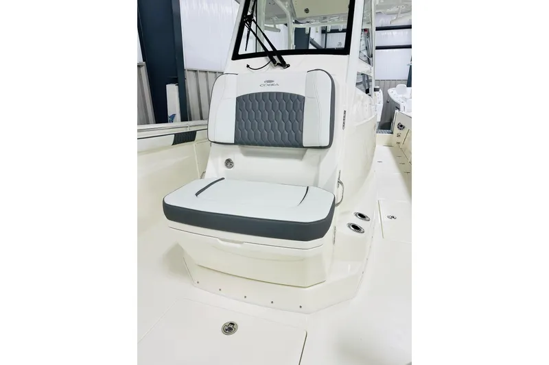 Slide: The Image of 2026 Cobia 305 Center Console boat interior with cushioned seating and modern design. - 10