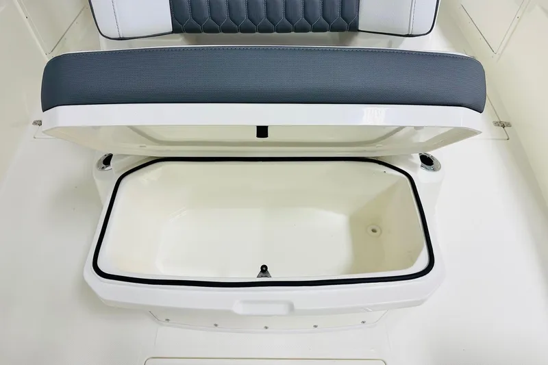 Slide: The Image of 2026 Cobia 305 Center Console boat seat with open storage compartment. - 11
