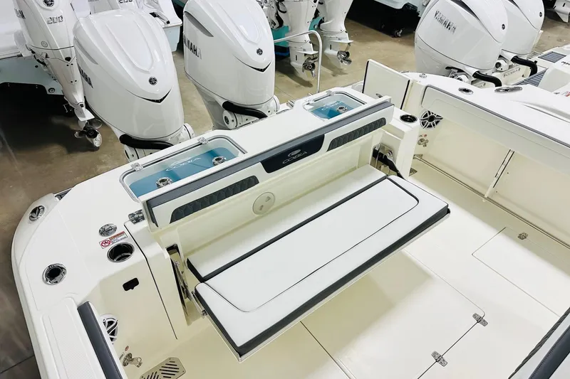 Slide: The Image of 2026 Cobia 305 Center Console boat with Yamaha outboard engines and foldable seating. - 14