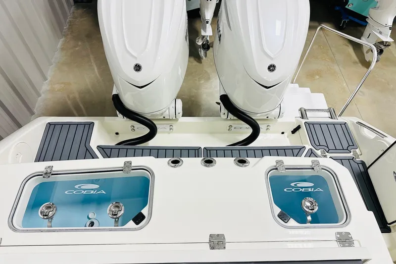 Slide: The Image of 2026 Cobia 305 Center Console boat with dual engines and live wells. - 15