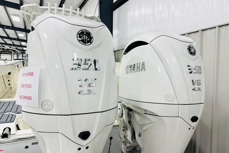 Slide: The Image of 2026 Cobia 305 Center Console with twin Yamaha 350 V6 engines in a showroom. - 17