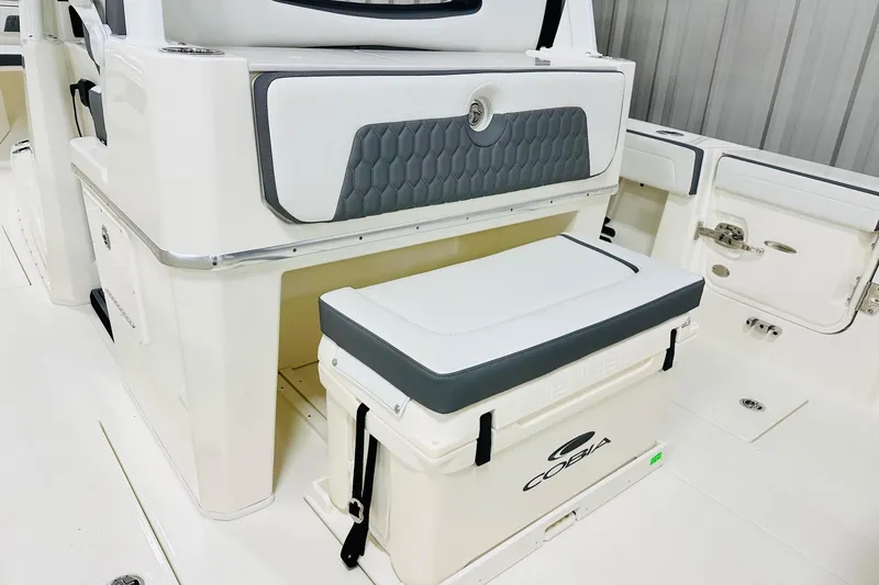 Slide: The Image of 2026 Cobia 305 Center Console boat interior with cushioned seating and storage. - 6