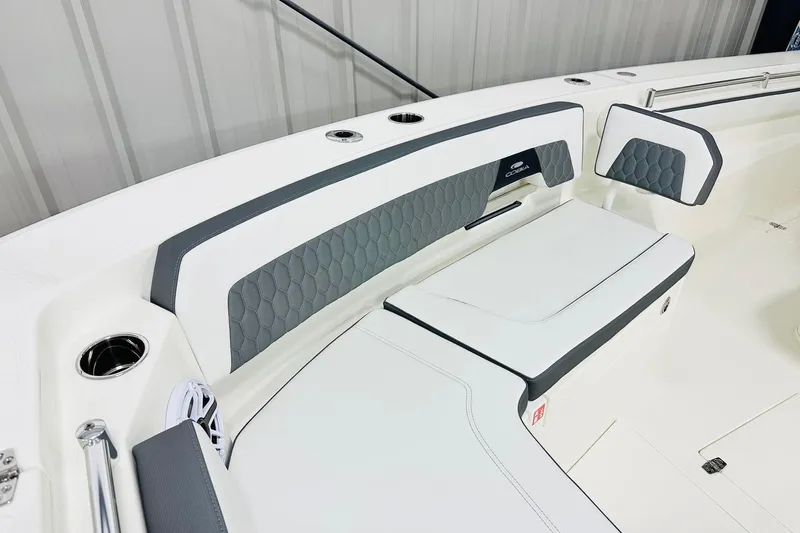 Slide: The Image of 2026 Cobia 305 Center Console boat interior with cushioned seating and modern design. - 8