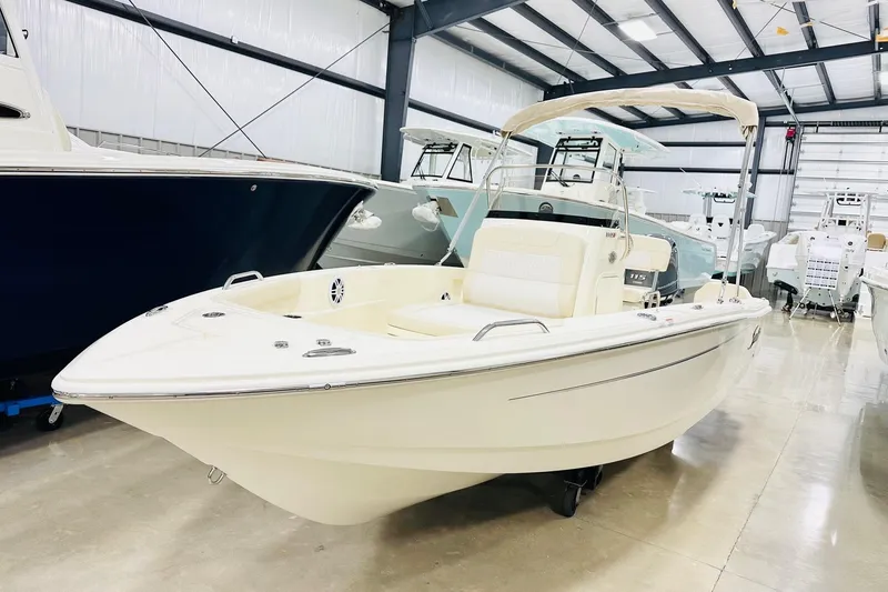 The Image of 2026 Scout 188 Sportfish boat in showroom, featuring sleek design and modern amenities. - 1