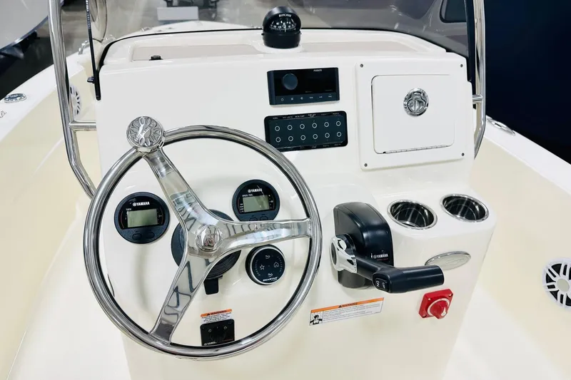 Slide: The Image of 2026 Scout 188 Sportfish boat console with steering wheel, Yamaha controls, and cup holders. - 3