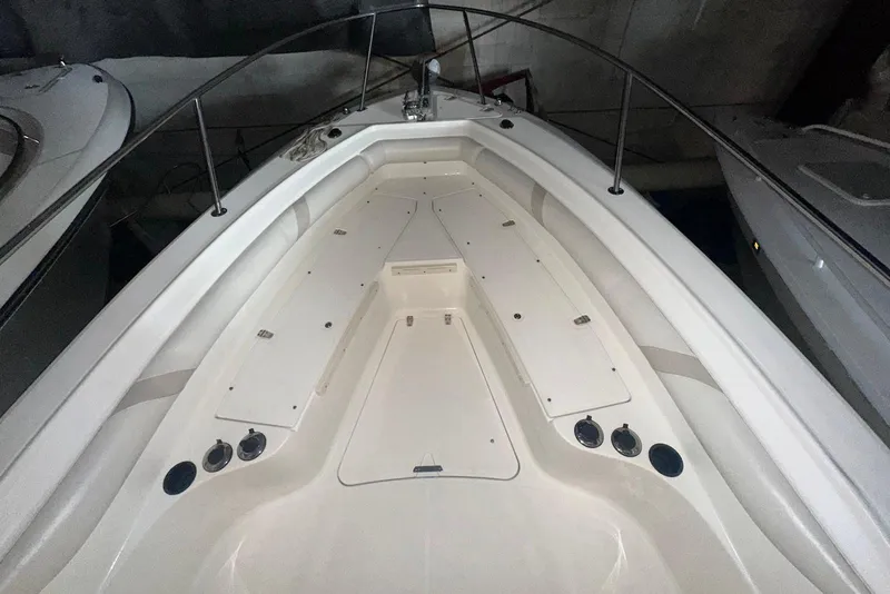 Slide: The Image of 2005 Boston Whaler 270 Outrage boat interior with cushioned seating and stainless steel railings. - 13