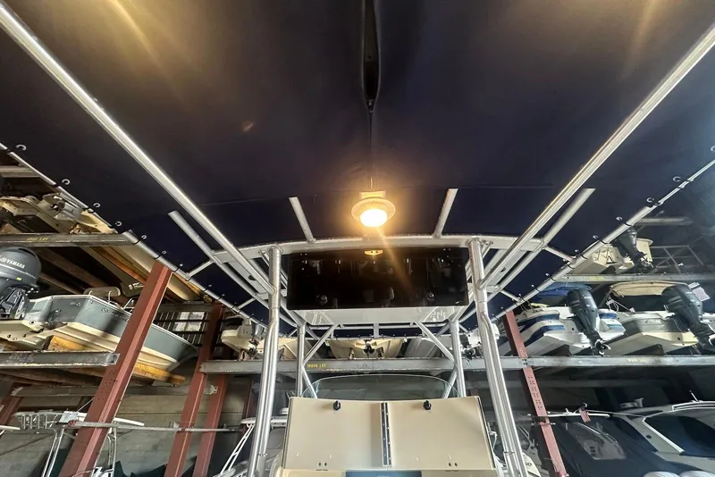 Slide: The Image of 2005 Boston Whaler 270 Outrage boat stored in a covered marina with overhead lighting. - 22