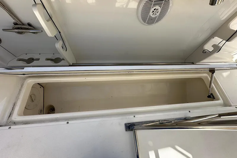Slide: The Image of 2005 Boston Whaler 270 Outrage storage compartment with stainless steel fittings and speaker. - 24