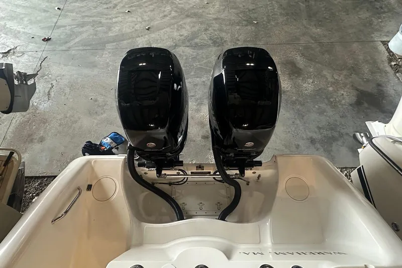 Slide: The Image of 2005 Boston Whaler 270 Outrage boat with Mercury engine, docked outdoors. - 5