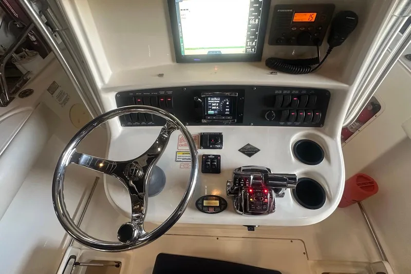 Slide: The Image of 2005 Boston Whaler 270 Outrage boat in storage facility, elevated on forklift. - 6