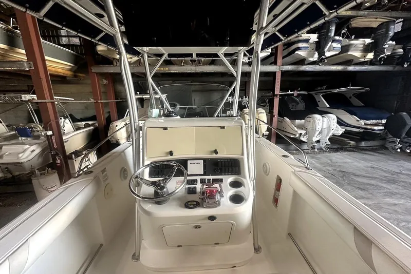 Slide: The Image of 2005 Boston Whaler 270 Outrage with twin 250 Verado engines, docked outdoors. - 7