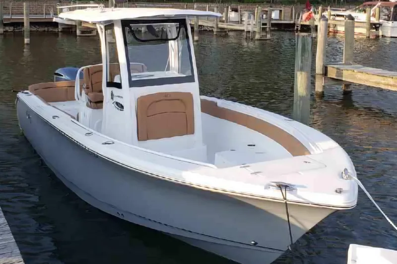 Slide: The Image of 2021 Sea Hunt Ultra 255 SE boat docked in a marina. - 0