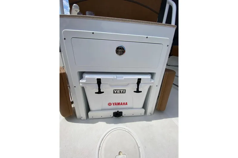 Slide: The Image of 2021 Sea Hunt Ultra 255 SE boat with Yeti cooler and Yamaha branding. - 10