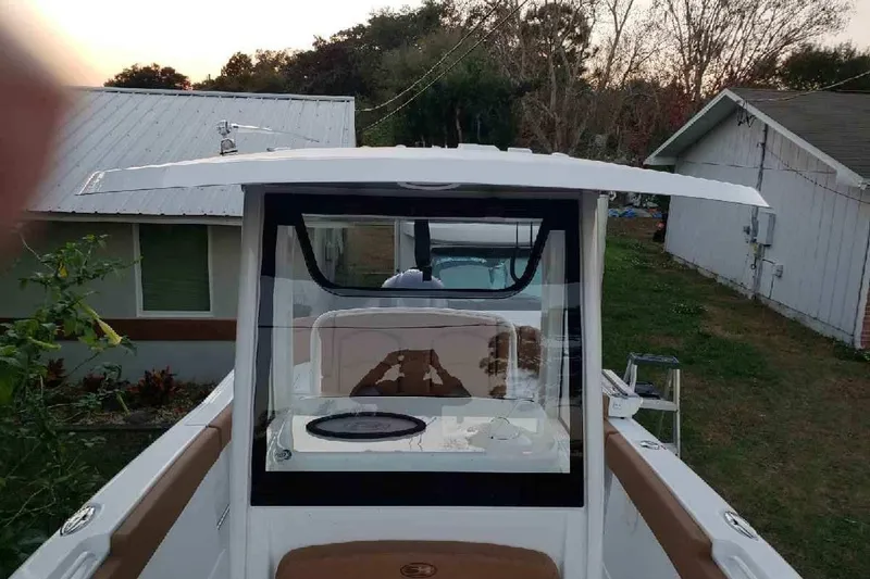 Slide: The Image of 2021 Sea Hunt Ultra 255 SE boat, view from the deck, residential background. - 18
