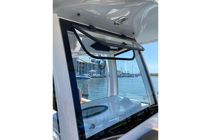 Slide: The Image of 2021 Sea Hunt Ultra 255 SE boat windshield with marina view. - 20