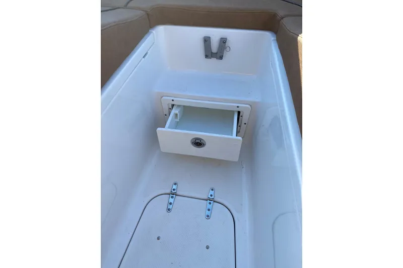 Slide: The Image of 2021 Sea Hunt Ultra 255 SE boat storage compartment with open drawer. - 22