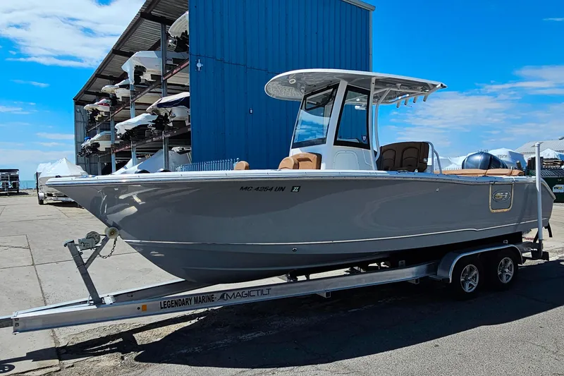 Slide: The Image of 2021 Sea Hunt Ultra 255 SE boat on trailer, parked outdoors near storage facility. - 27