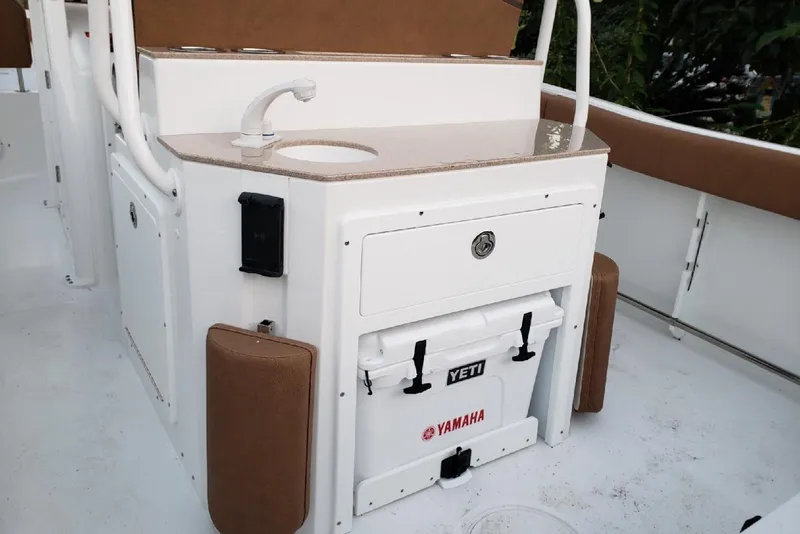 Slide: The Image of 2021 Sea Hunt Ultra 255 SE boat interior with sink and Yeti cooler. - 5