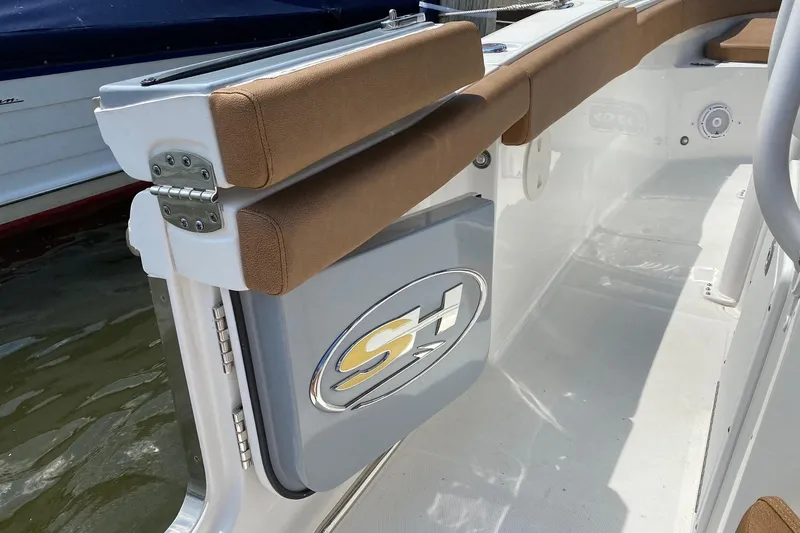 Slide: The Image of 2021 Sea Hunt Ultra 255 SE boat interior with cushioned seating and logo detail. - 6