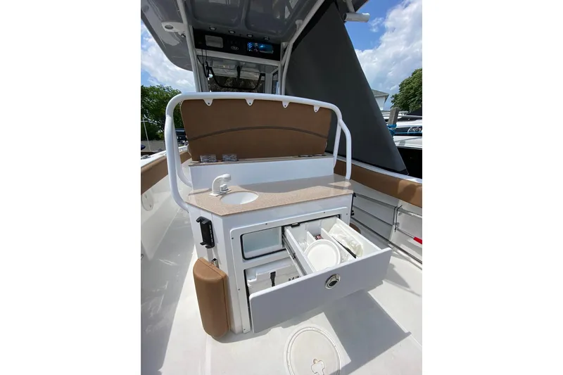 Slide: The Image of 2021 Sea Hunt Ultra 255 SE boat interior with sink and storage drawers. - 8