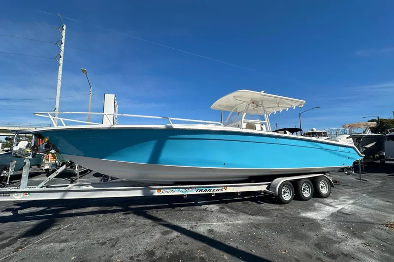 The Image of 2004 Marlago 35 FS boat on trailer under clear blue sky. - 0