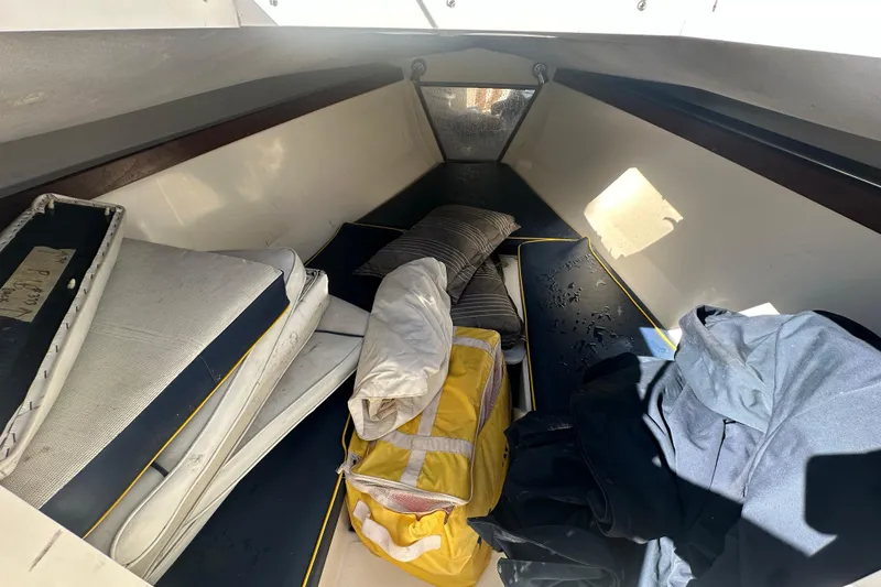 Slide: The Image of Interior cabin of a 2004 Marlago 35 FS boat with cushions and gear. - 10