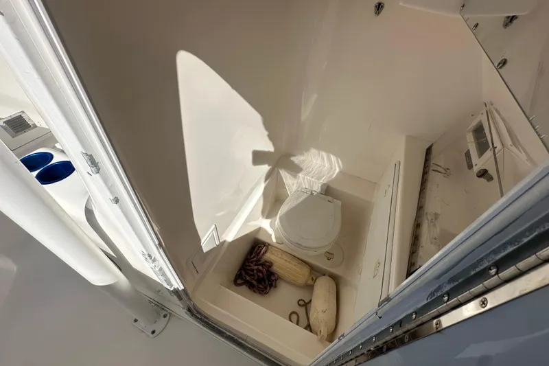 Slide: The Image of 2004 Marlago 35 FS boat interior with toilet and storage area. - 12