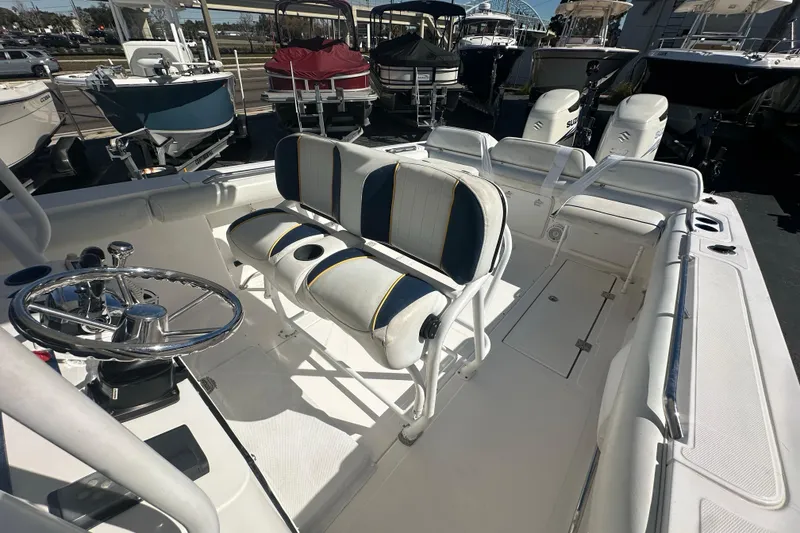 Slide: The Image of 2004 Marlago 35 FS boat interior with dual seating and steering wheel. - 14