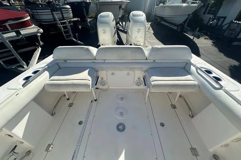 Slide: The Image of 2004 Marlago 35 FS boat interior with seating and dual outboard engines. - 18