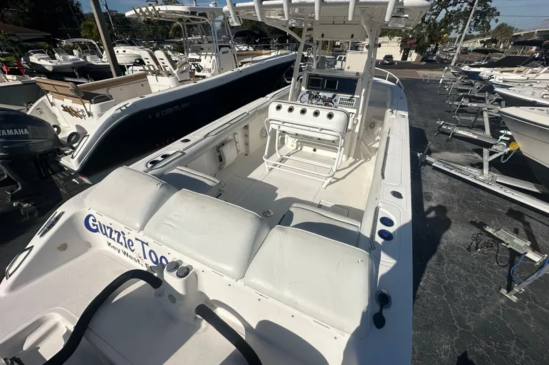 Slide: The Image of 2004 Marlago 35 FS boat in marina, featuring spacious deck and control console. - 20