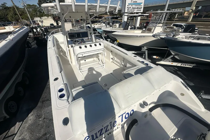 Slide: The Image of 2004 Marlago 35 FS boat, white interior, docked among other boats at a marina. - 22