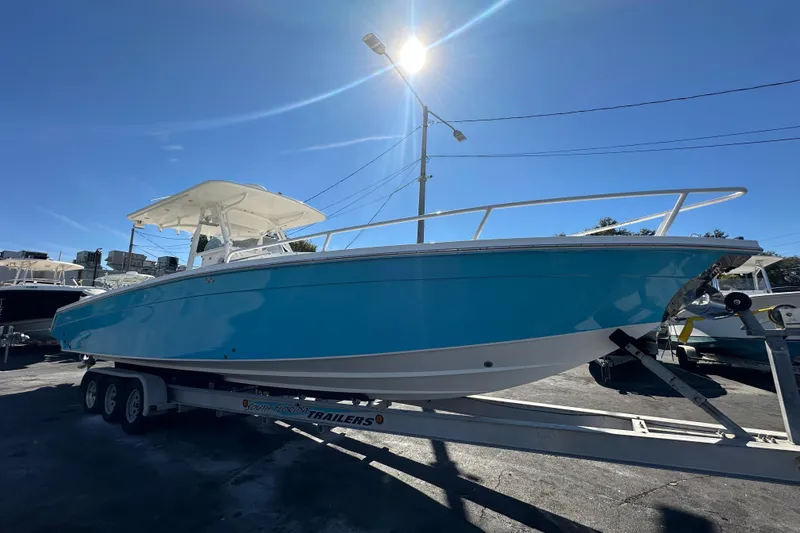 Slide: The Image of 2004 Marlago 35 FS boat on trailer under bright sunlit sky. - 6